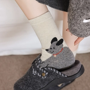Close-up of cute cartoon dog pattern on thick wool blend mid-calf socks for women