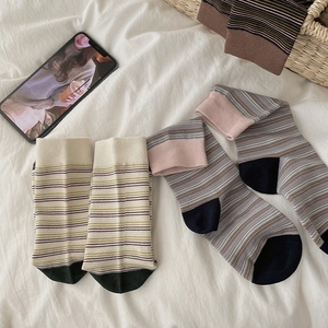 Detail of vintage striped cotton mid-calf socks with ribbed cuffs and contrast toe
