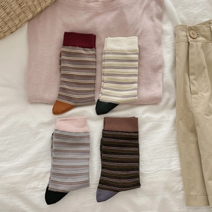 Detail of four pairs of striped cotton crew socks with contrasting toes and cuffs