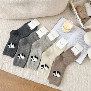 Five pairs of thick wool socks with cute panda patterns in neutral winter colors