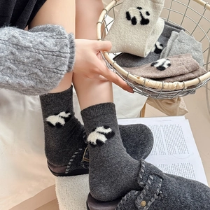 Detail of wool-blend panda socks in neutral tones for winter warmth and cozy home style