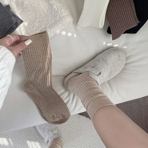 Detail of ribbed knit crew socks in neutral tones with warm texture for winter