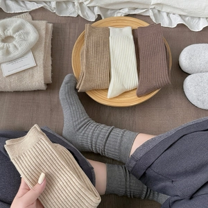 Close-up of warm ribbed crew socks in earth tones featuring thick knit cotton texture