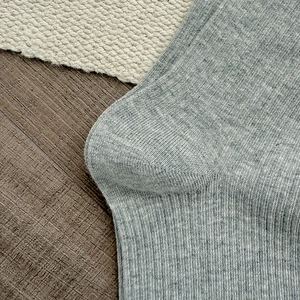 Macro view of grey rib-knit cotton socks with textured melange finish and heel detail