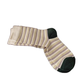 Retro striped crew socks in white with multi-color accents and green contrast heel
