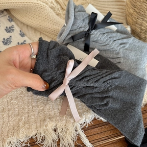 Detailed knit texture of mid-calf socks with sweet ribbon bows and soft cotton material