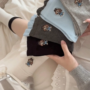 Detail of cute dog embroidery on ribbed cotton socks with ruffled edges in multiple colors
