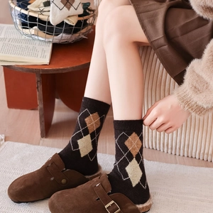 Detail of warm argyle knit socks in dark chocolate brown with cozy wool texture