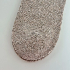 Detail of oatmeal knit socks showing reinforced toe stitching and wool blend texture