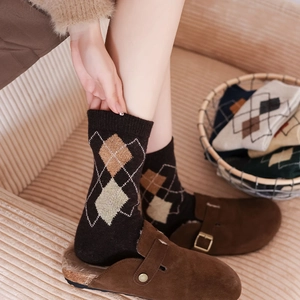 Detailed knit texture of vintage argyle wool socks in warm brown and beige tones
