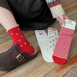 Floral crew socks with red bow, plaid pattern and ruffled trim for a sweet style