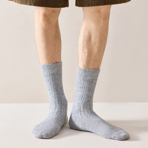 Mens thick wool crew socks in light grey with vintage knitted texture for winter warmth