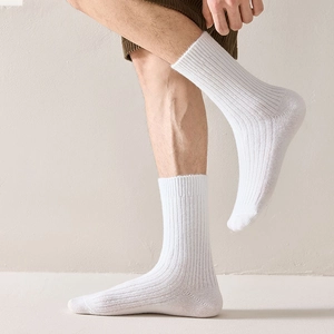 Detail of white ribbed wool socks showing premium knitted texture and elastic cuff