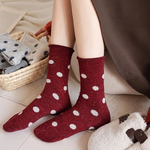 Deep red wool socks with white polka dots, thick thermal knit for winter comfort