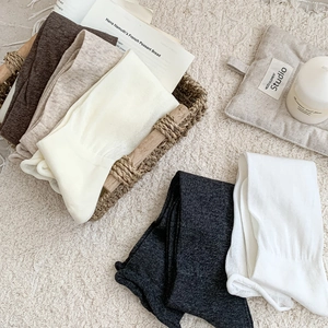 Close-up of knitted cotton socks in earth tones showing soft vertical ribbed texture