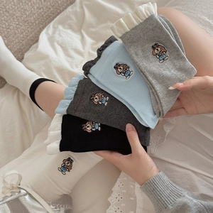 Detailed view of ruffle cuffs and cute puppy embroidery on cotton crew socks