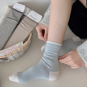 Detail of striped cotton crew socks featuring ribbed cuffs and a contrast heel design