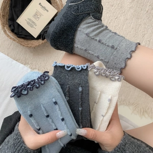 Cozy wool crew socks with polka dots and ruffle edges shown in multiple colors