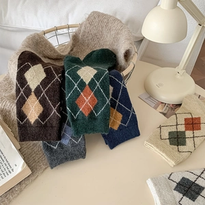 Detailed view of thick argyle wool socks in various warm colors for autumn and winter