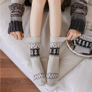 Winter crew socks with pine tree and red heart patterns in cozy knit style