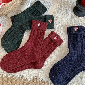 Detailed view of thick Christmas wool blend socks with snowman and santa embroidery