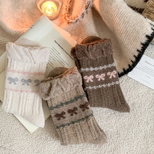 Detail of wool blend socks featuring bow tie patterns and vintage ribbed texture