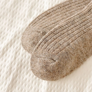Detailed close-up of thick ribbed wool knit texture in light brown for men socks