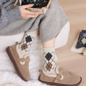 Women's vintage argyle wool socks paired with warm fleece-lined brown suede boots