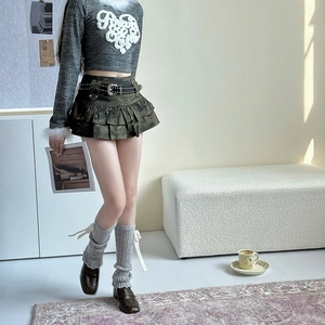 Close-up of knit leg warmers with ribbon bows and cozy soft texture in a Y2K outfit
