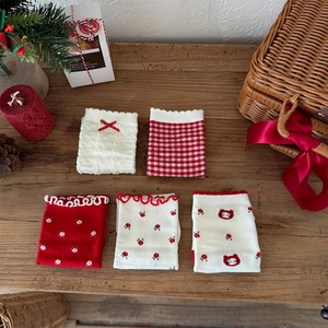 Detailed view of 5-pack Christmas themed knit socks with red bows and plaid patterns