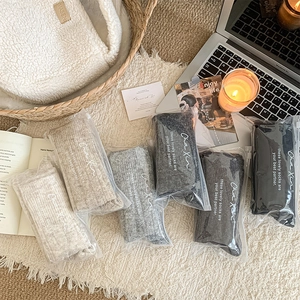 Over-the-knee socks in six neutral colors packed in neat transparent zipper bags