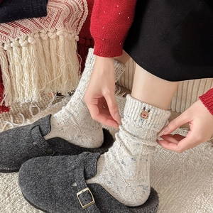 Thick wool Christmas socks with reindeer embroidery and colorful speckled texture