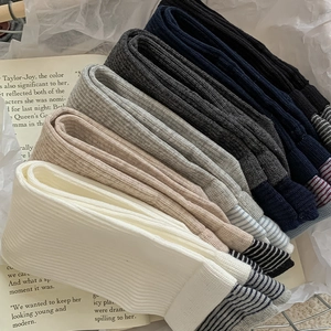 Close-up of ribbed cotton socks with striped toe detail in five various neutral colors