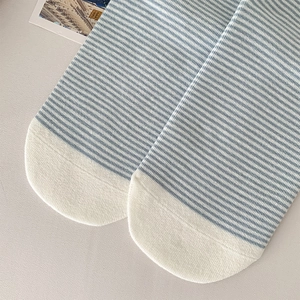 Detail view of blue and white striped cotton socks with reinforced cream white toe part