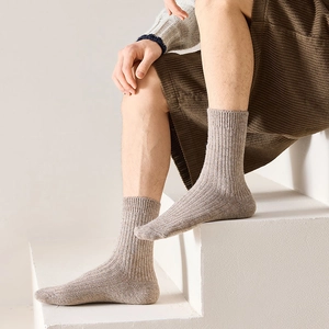 Close-up of ribbed texture on oatmeal wool mid-calf socks for men with warm knit finish