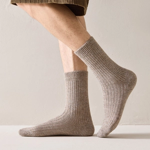 Detailed macro view of light brown wool blend ribbed socks with reinforced toe and heel