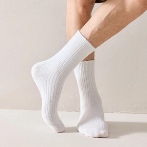 Detailed view of white ribbed wool texture on men's mid-calf socks with elastic fit