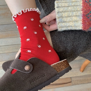 Floral red knit socks with white ruffles and flower pattern in vintage style