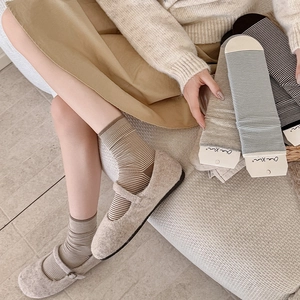Detailed texture of thin striped cotton crew socks with ribbed cuffs and soft fabric