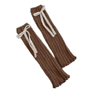 Brown knitted leg warmers with white plush bows and vertical ribbed texture design
