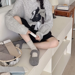 Close-up of minimalist striped crew socks paired with gray buckle shoes in a lifestyle setting