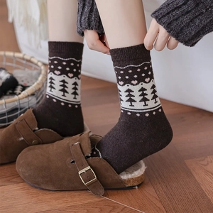 Winter crew socks with pine tree and heart patterns, styled with warm fur-lined clogs