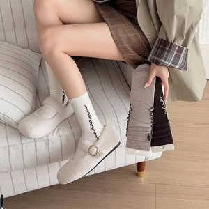 Women's ruffle wool socks in white and brown styled with plush Mary Jane shoes