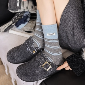 Women's warm striped crew socks and felt mules with buckle in cozy lifestyle setting
