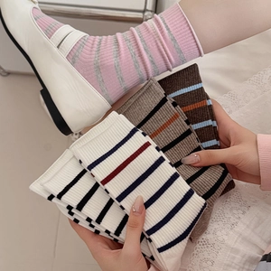 Close-up of pink and grey striped crew socks with ribbed texture and elastic cuffs
