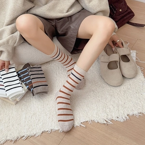 Detail of pink and grey striped crew socks with elastic ribbed cuffs and soft cotton texture