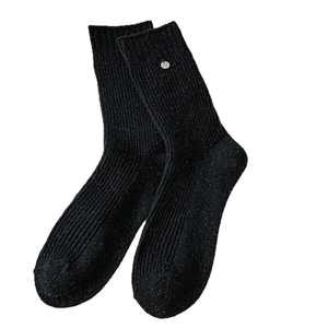 Thick black wool knit socks with silver decorative buttons and ribbed texture for winter