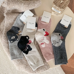 Close-up of thick wool socks with cute animal embroidery like bears and rabbits