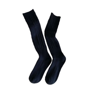 Vertical rib knit knee-high socks in black color for a classic minimalist winter look