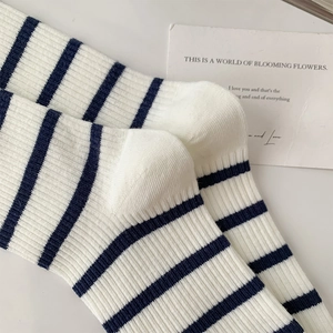 Detail of ribbed knit texture on striped cotton socks with cozy stacking effect